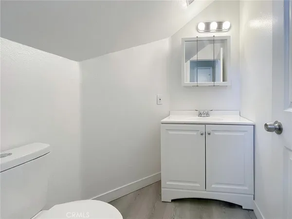 a bathroom with a sink vanity and a toilet