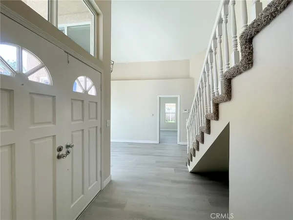 a view of entryway and hallway with a front door