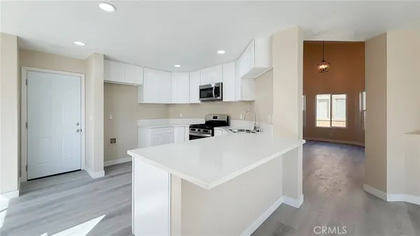 a view of a kitchen cabinets and wooden floor
