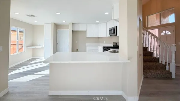 a view of kitchen with furniture and refrigerator