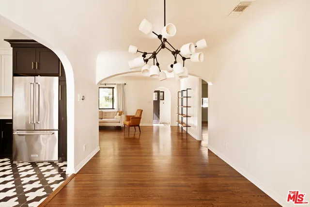 a view of a living room with hardwood floor and a ceiling fan