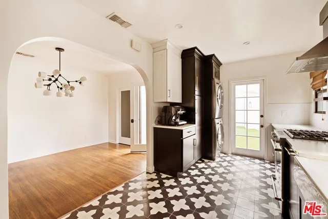 a kitchen with a refrigerator and a stove top oven
