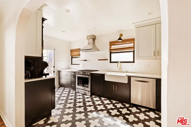 a kitchen with stainless steel appliances a sink stove and refrigerator