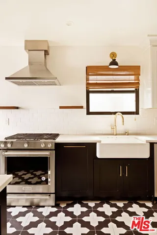 a kitchen with a sink and a stove