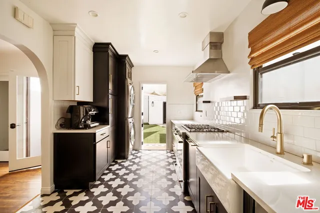 a kitchen with a sink stove and refrigerator