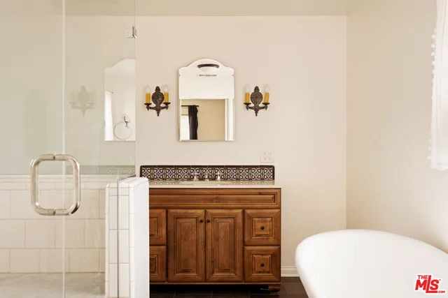 a bathroom with a granite countertop toilet sink and mirror