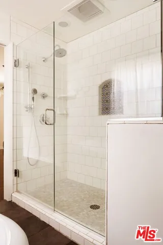 a bathroom with a shower and a sink
