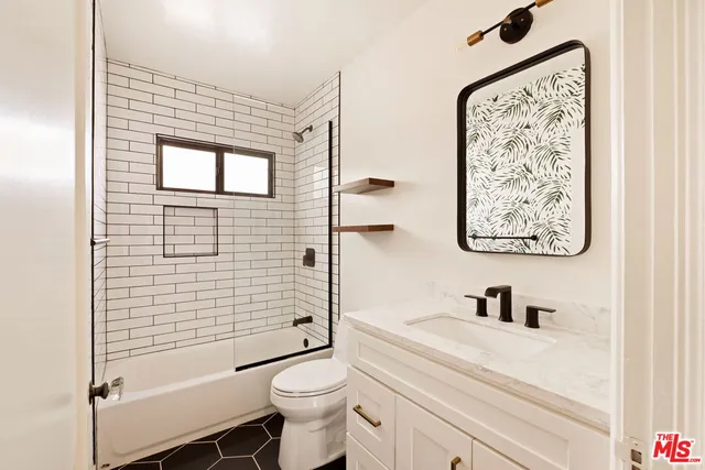 a bathroom with a toilet a sink and shower