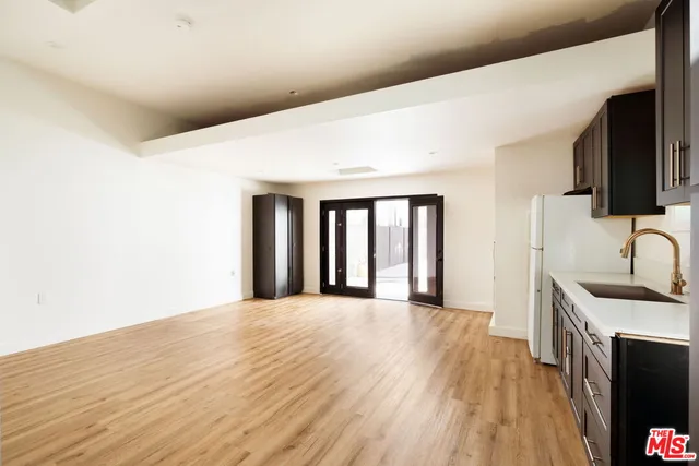 a view of a kitchen with an entryway and a wooden floor