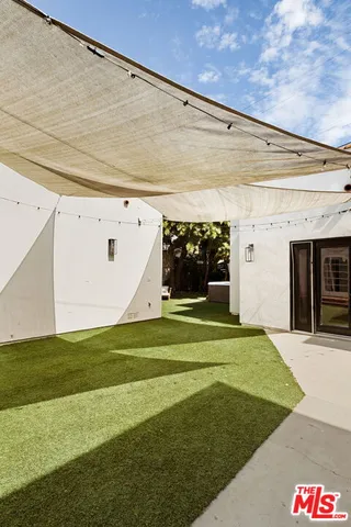 a backyard of a house with table and chairs