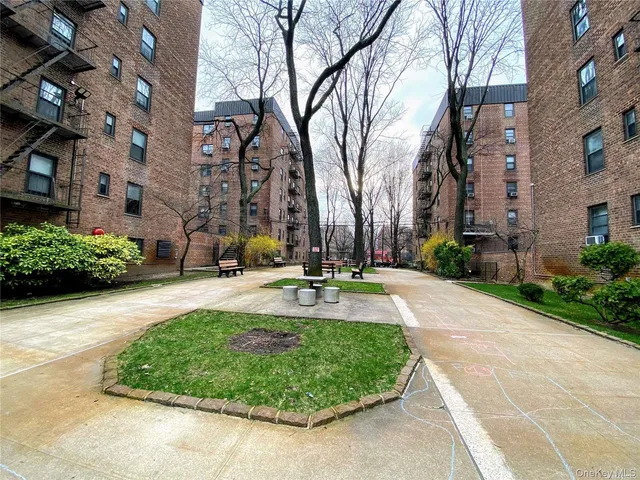 a view of a fountain in front of a brick building