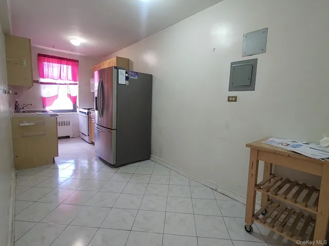 a kitchen with a cabinets and a refrigerator