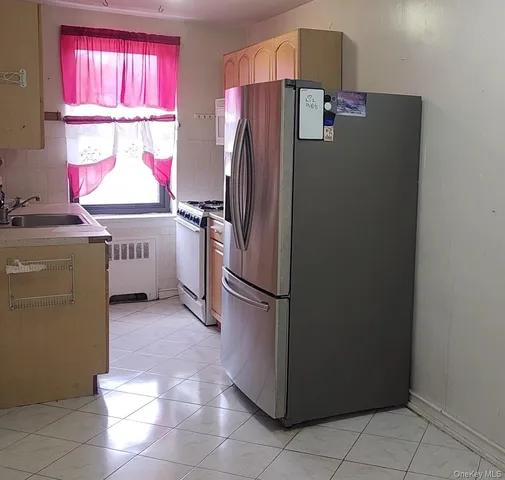 a kitchen with a refrigerator a stove a washer and dryer