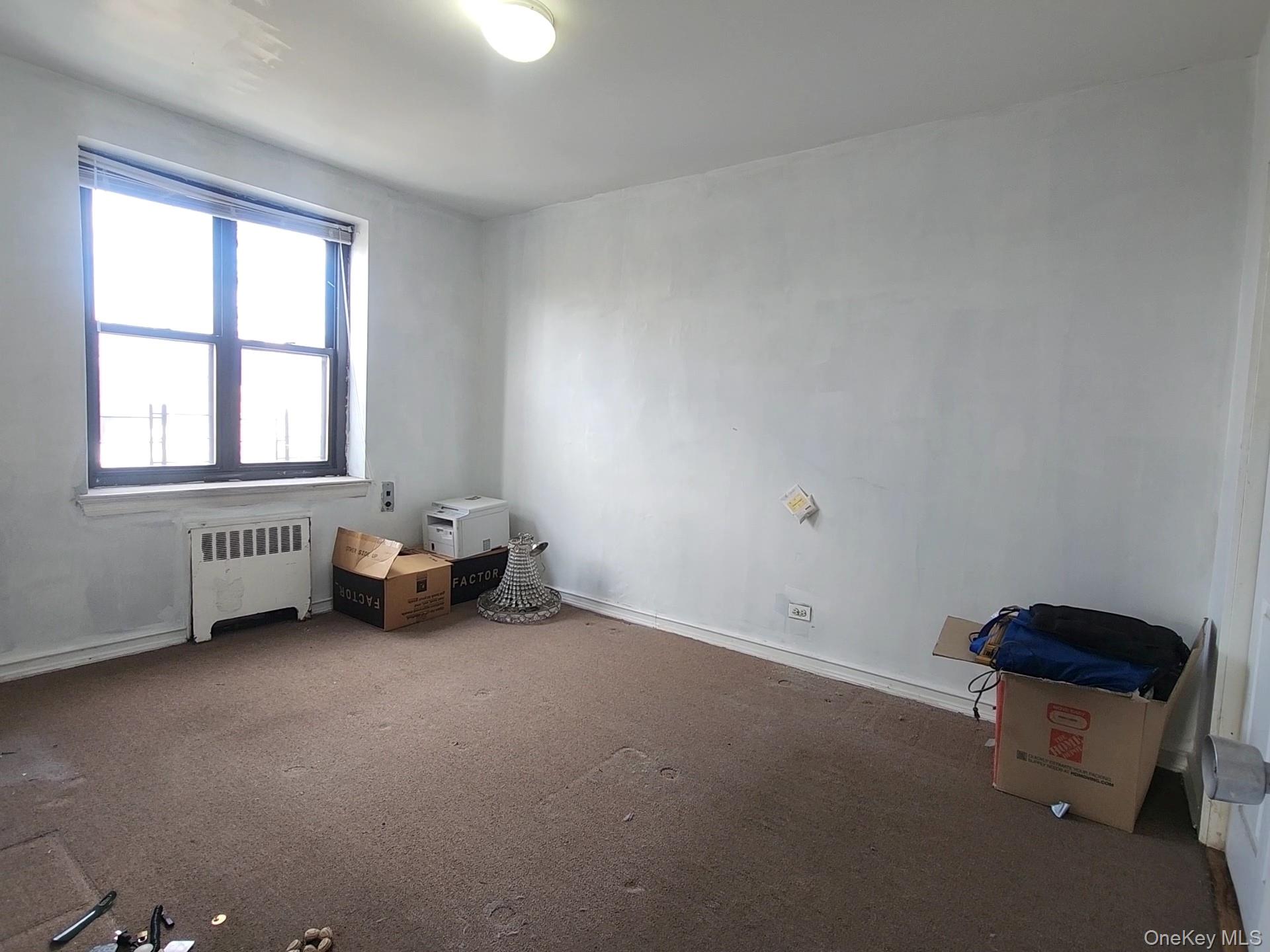 90-09 Northern Boulevard, Unit 303 Queens, NY 11372 - Photo 9 of 15 an empty room with windows