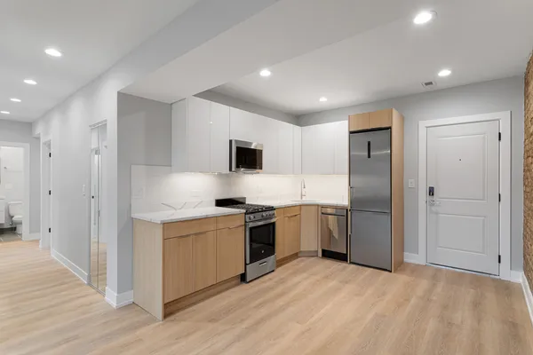 a kitchen with a refrigerator and a sink