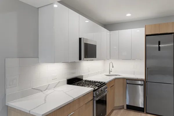 a kitchen with a sink stove and refrigerator