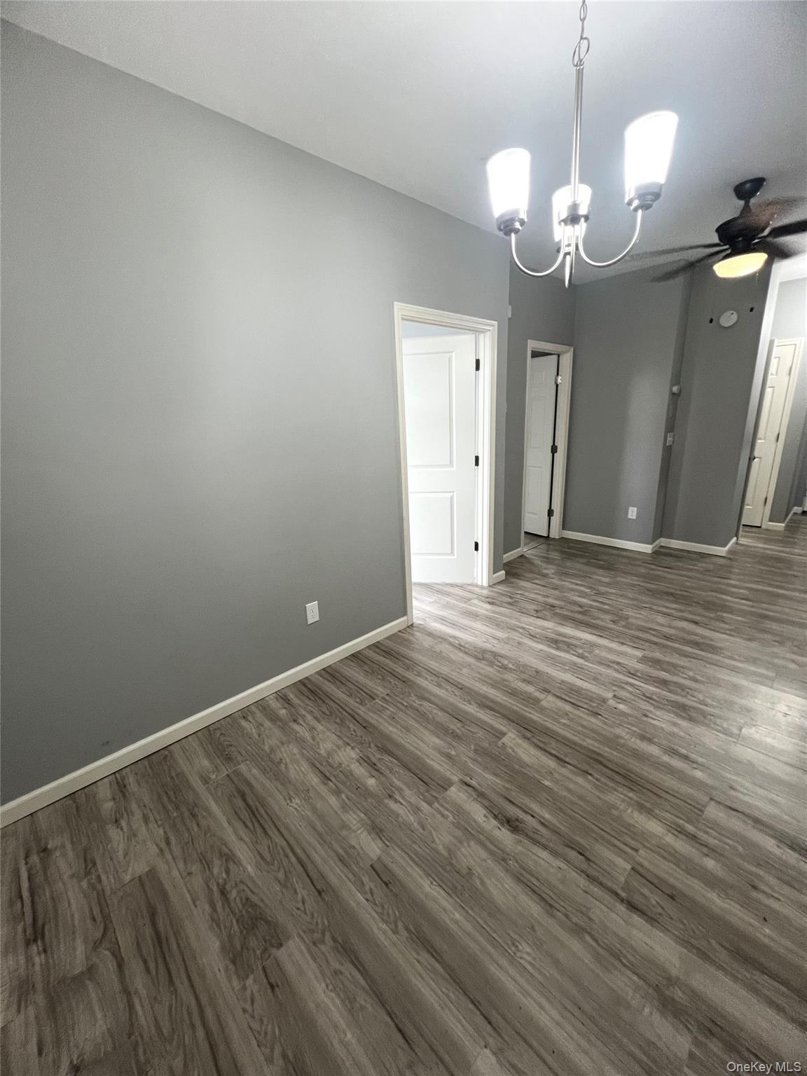 39 Church Street, Unit 53 Port Jervis, NY 12771 - Photo 11 of 32 a view of wooden floor and a chandelier in a room