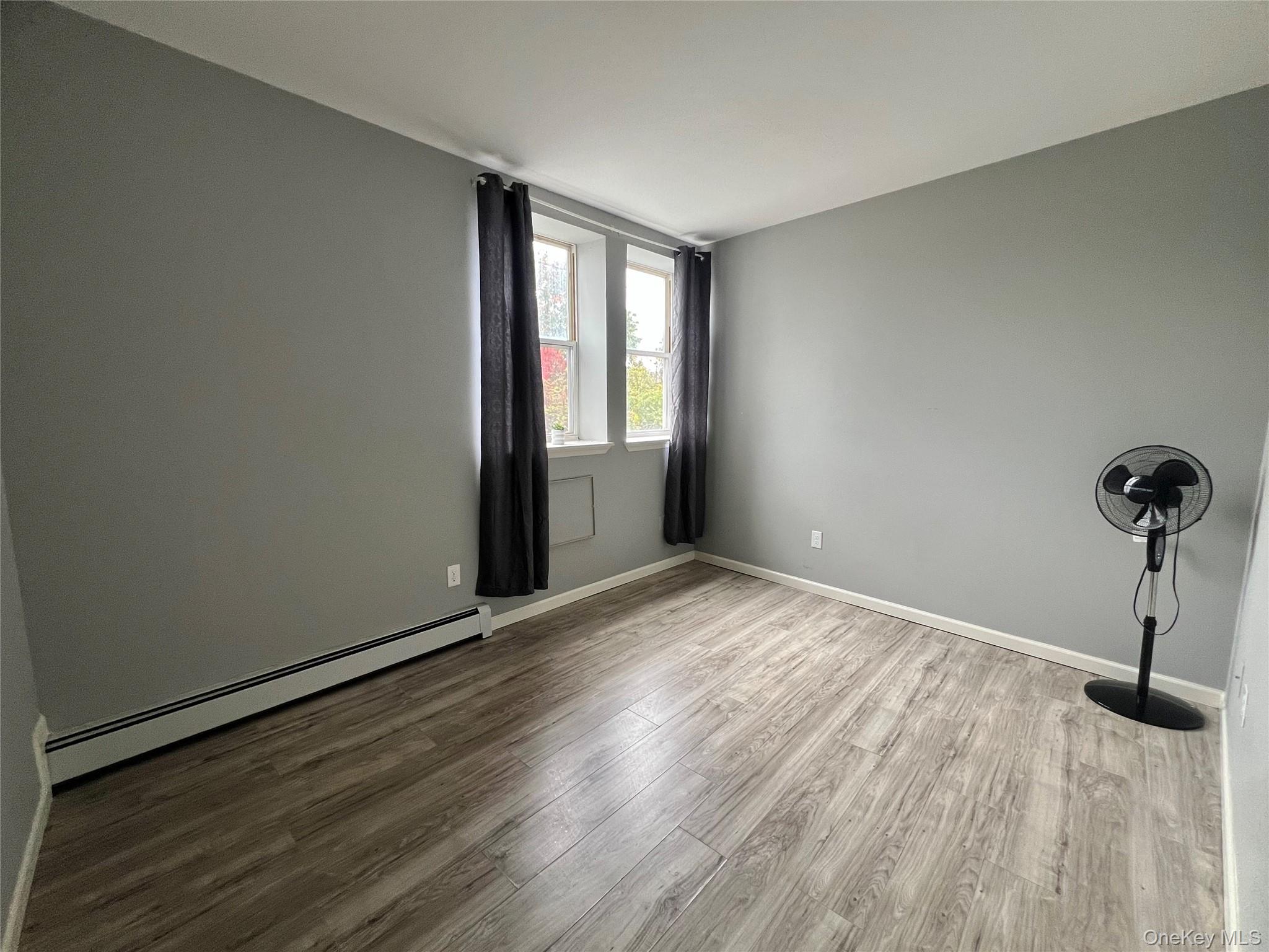 39 Church Street, Unit 53 Port Jervis, NY 12771 - Photo 15 of 32 a view of empty room with wooden floor and fan