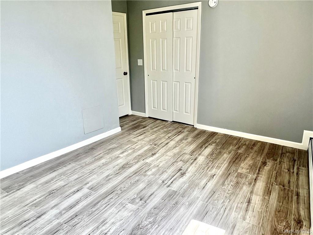 39 Church Street, Unit 53 Port Jervis, NY 12771 - Photo 21 of 32 a view of an empty room with wooden floor