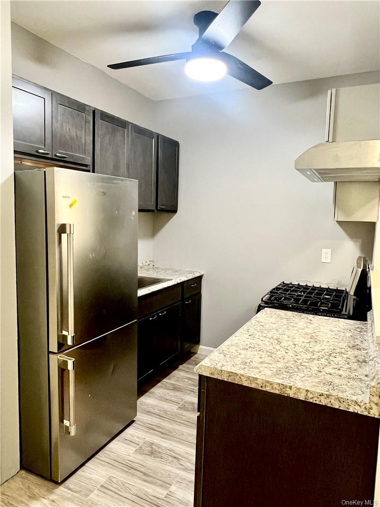 39 Church Street, Unit 53 Port Jervis, NY 12771 - Photo 3 of 32 a kitchen with granite countertop a refrigerator a sink and cabinets