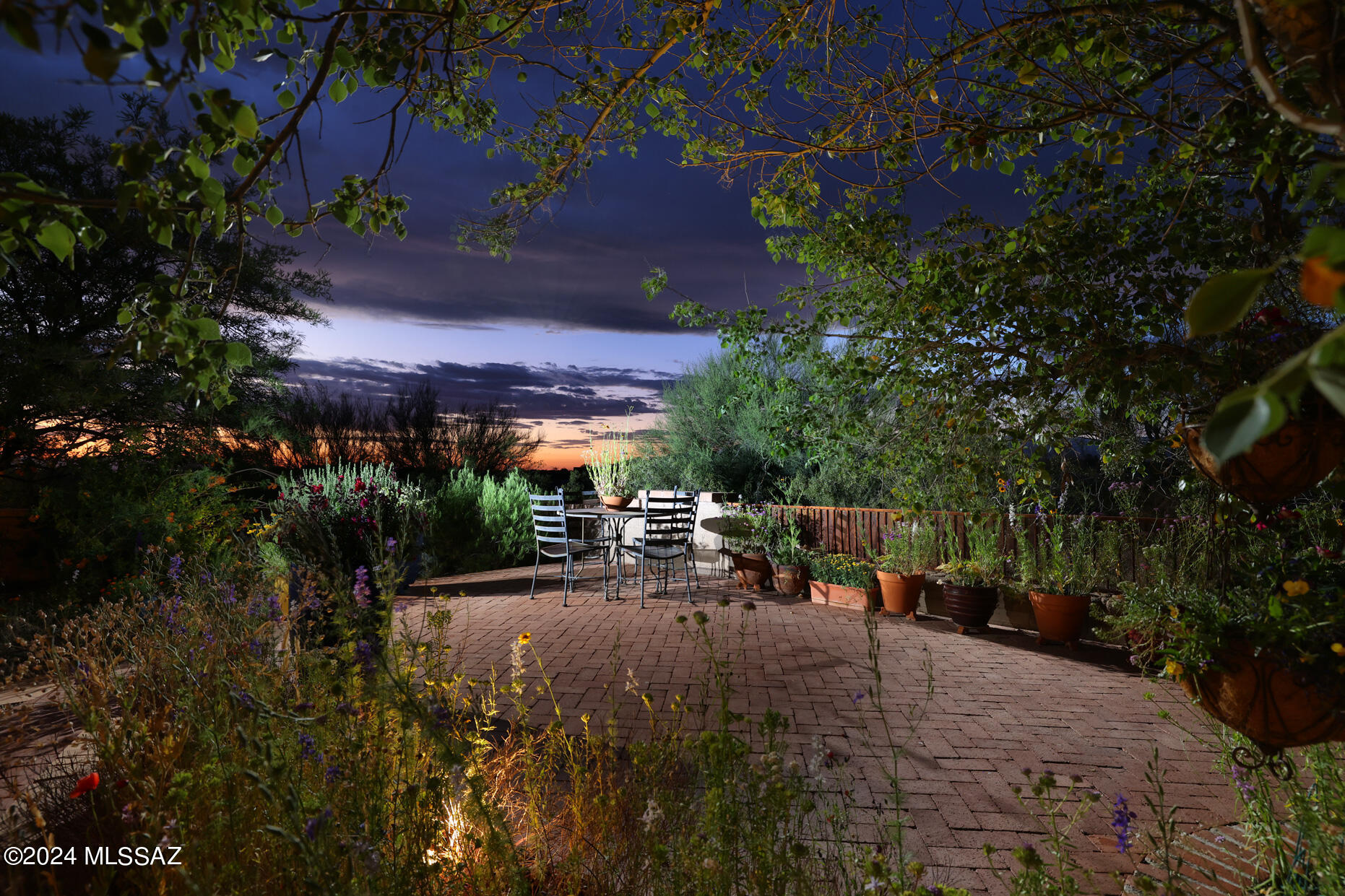 11725 East Spanish Ridge Place Tucson, AZ 85730 - Photo 46 of 51 a view of a patio with table and chairs and potted plants