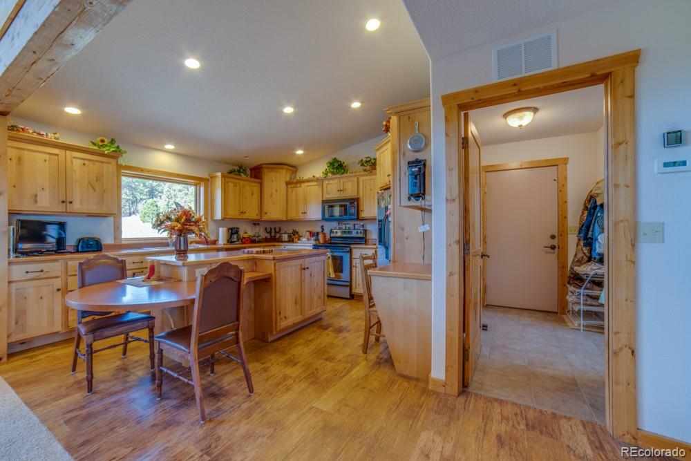 8615 Highway 165 Rye, CO 81069 - Photo 12 of 37 a kitchen with stainless steel appliances granite countertop a refrigerator and a stove top oven