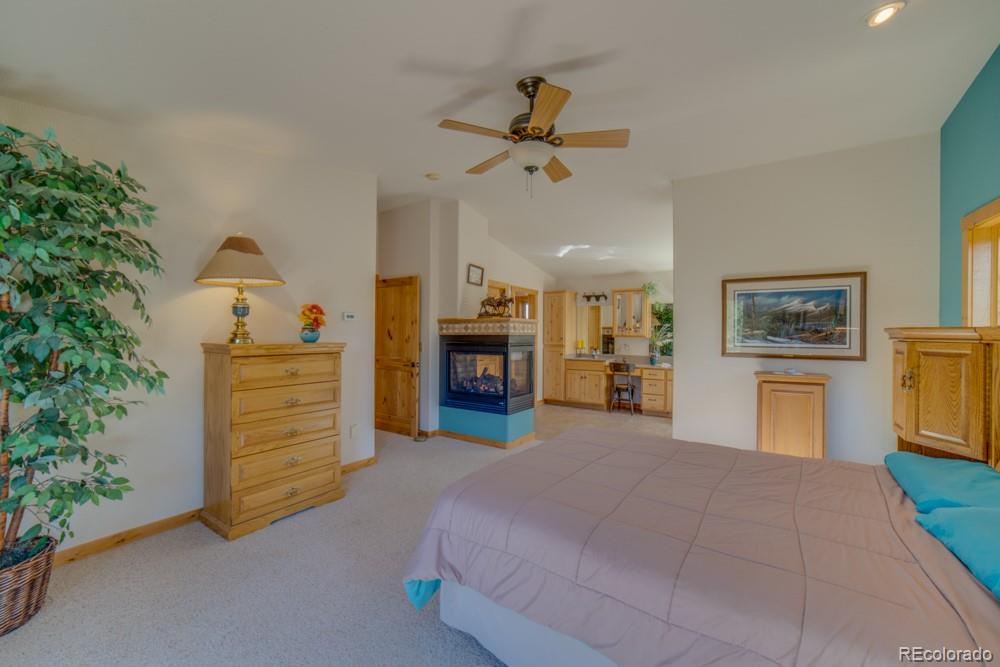 8615 Highway 165 Rye, CO 81069 - Photo 30 of 37 a bedroom with a bed and a chandelier