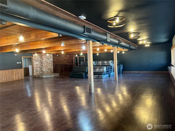 a view of a room with wooden floor and stairs