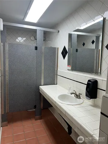 a bathroom with a sink toilet and shower