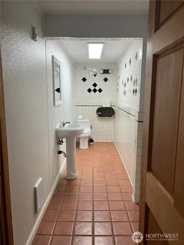 an empty room with wooden floor and a window