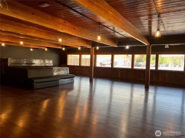 a view of a hall with wooden floor