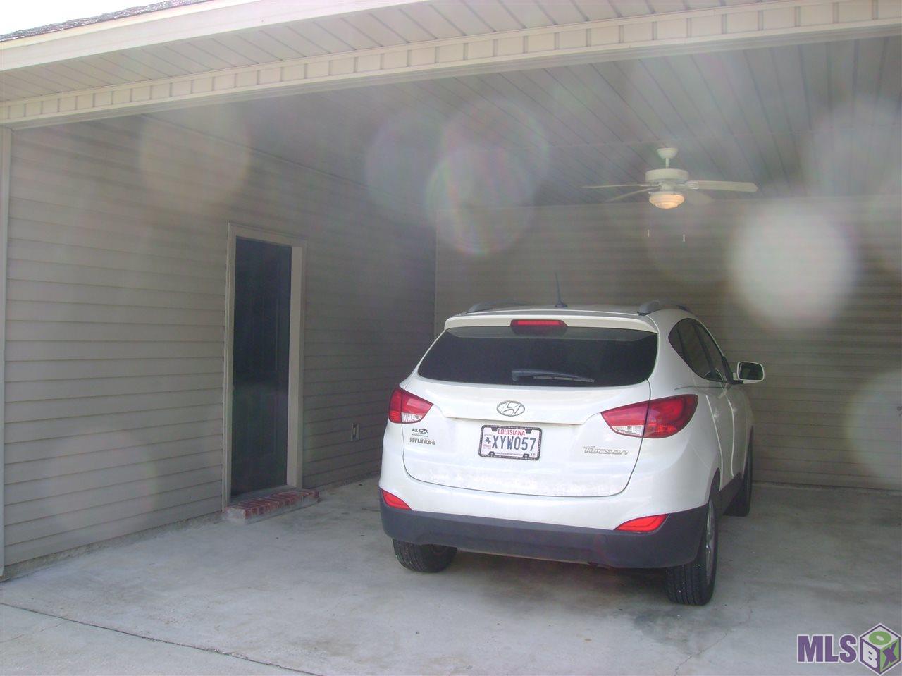 9348 Rue De Benoit Denham Springs, LA 70706 - Photo 8 of 36 Rear carport with storage room