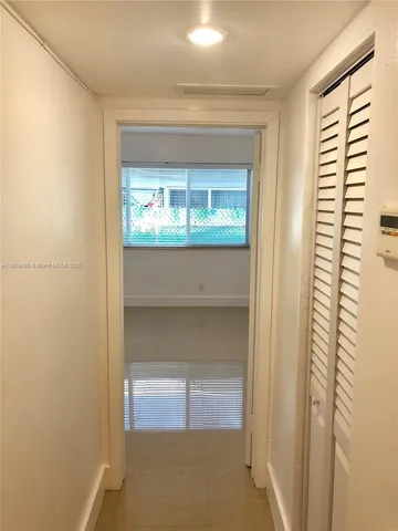 a living room with a wooden floor and a window