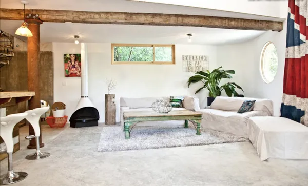 a living room with furniture and a lamp