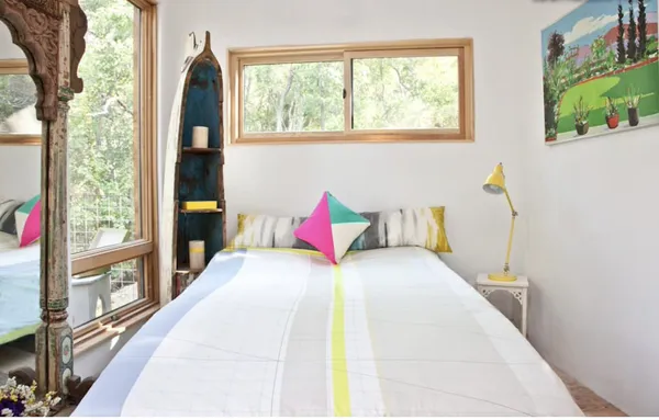 a bedroom with a bed and a large window