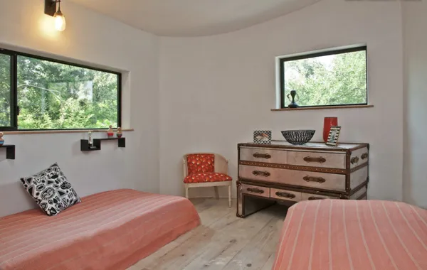 a bedroom with a bed and a window