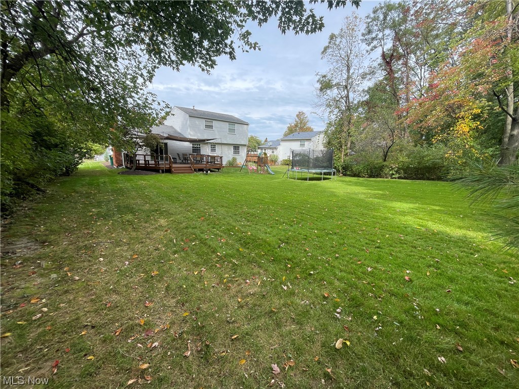9572 Hoose Road Mentor, OH 44060 - Photo 12 of 35 View of yard featuring a trampoline and a wooden deck