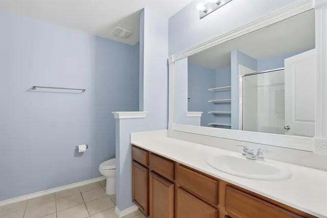 a bathroom with a sink a toilet a mirror and vanity