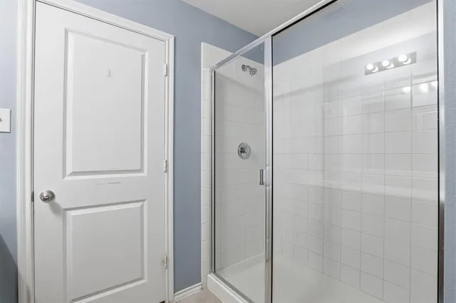 a bathroom with a glass shower door