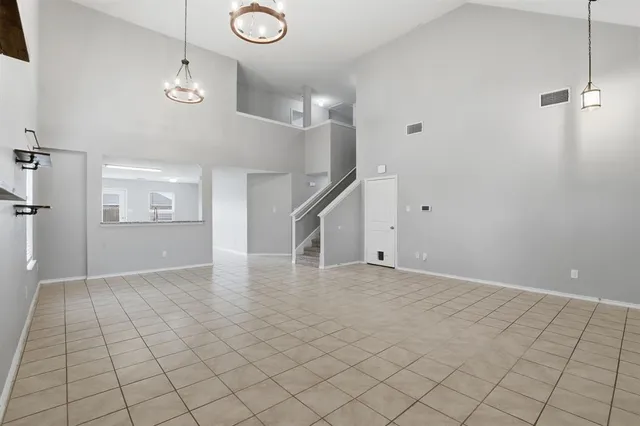 a view of an empty room and stairs