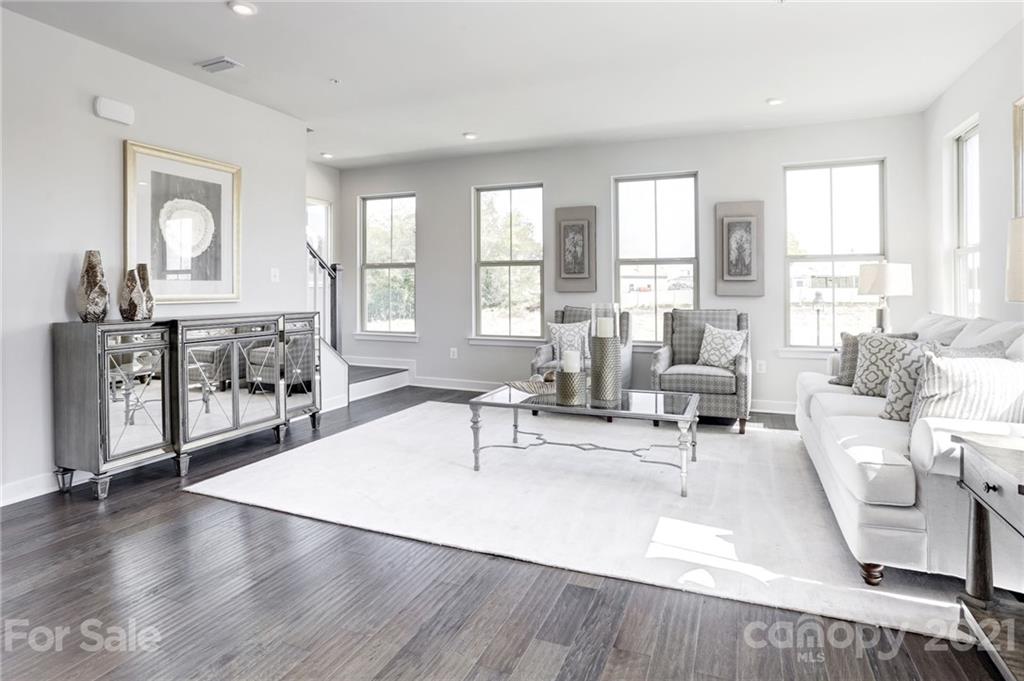 945 Portrush Lane, Unit 1011E Tega Cay, SC 29708 - Photo 5 of 12 a living room with furniture and a large window