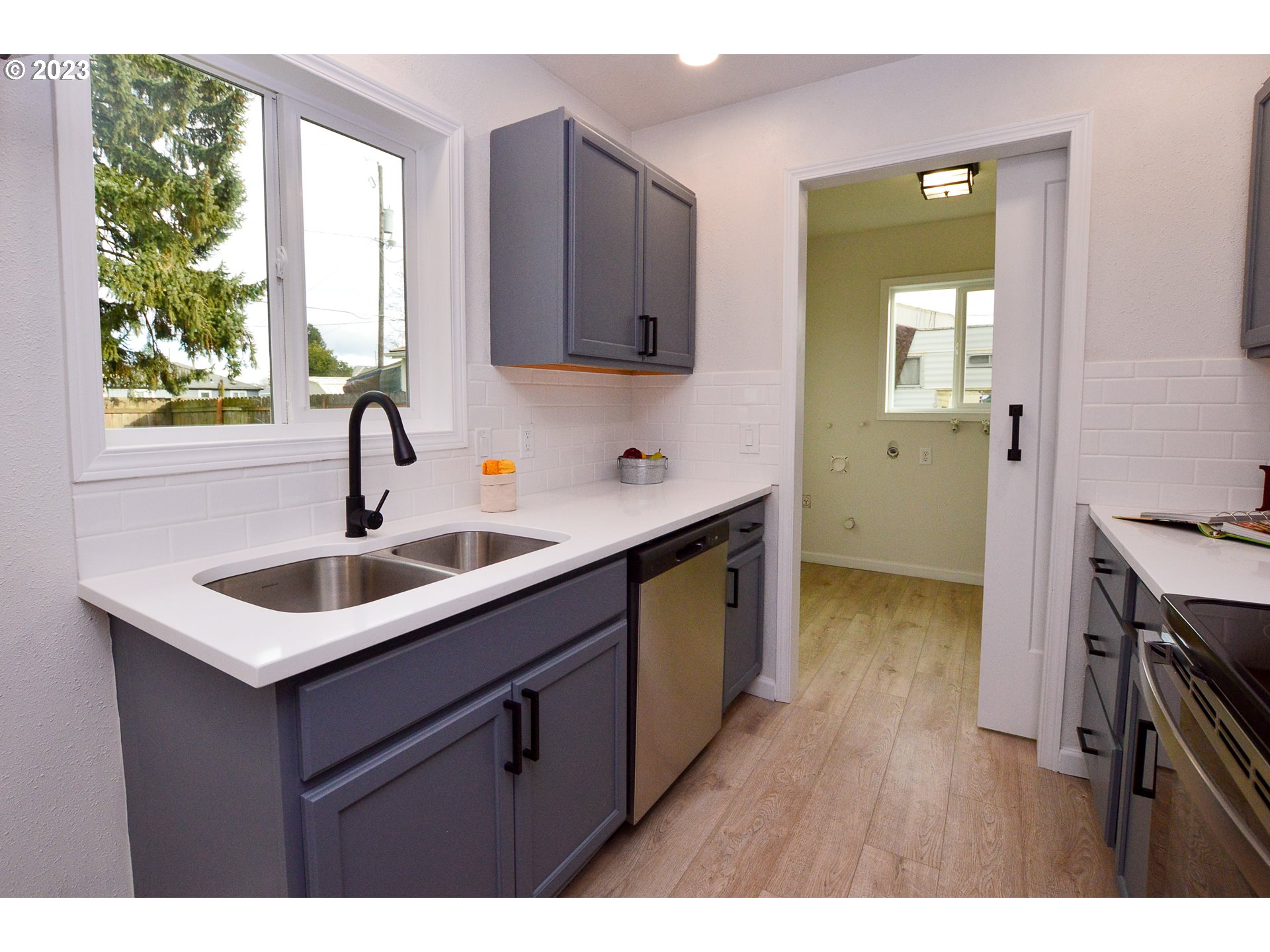 419 25th Street Springfield, OR 97477 - Photo 7 of 17 a kitchen with a sink cabinets and wooden floor