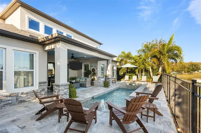 a spacious bathroom with double vanity a mirror and a shower