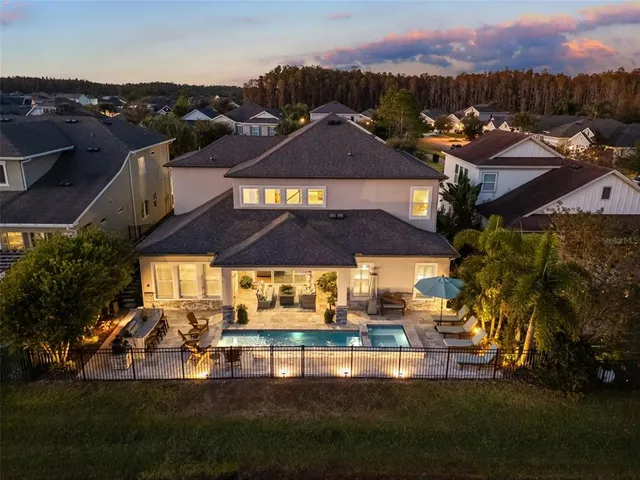 an aerial view of a house with a garden and lake view