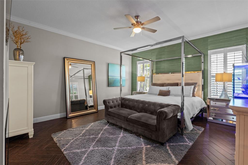 14822 Trails Edge Boulevard Odessa, FL 33556 - Photo 24 of 73 a spacious bedroom with a bed wooden floor and windows