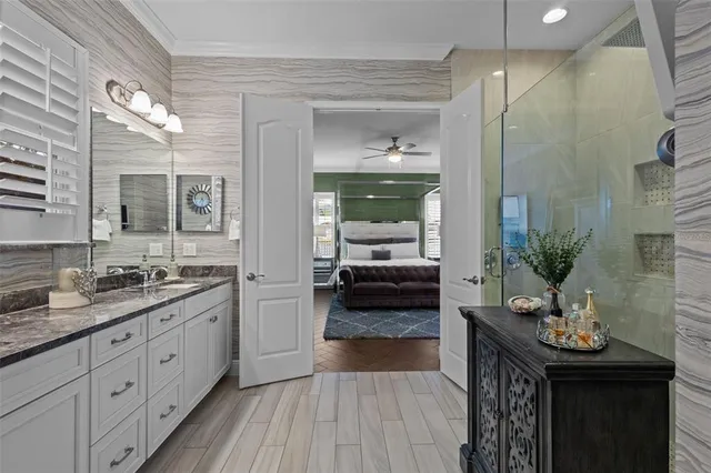 a bedroom with a bed window and a dresser in it