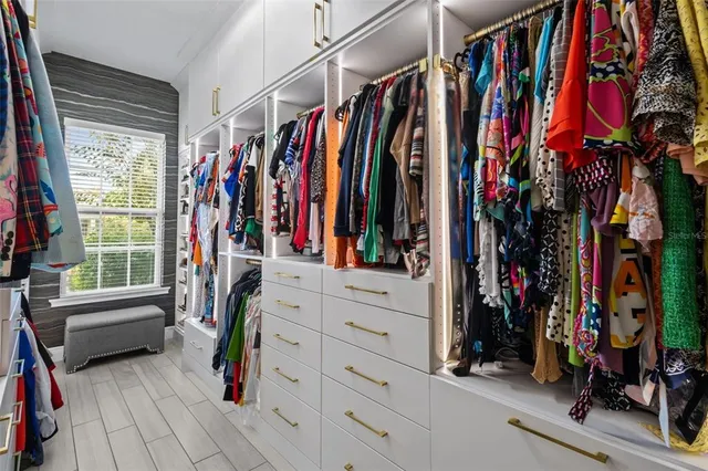 a bathroom with a granite countertop double vanity sink mirror and a bathtub