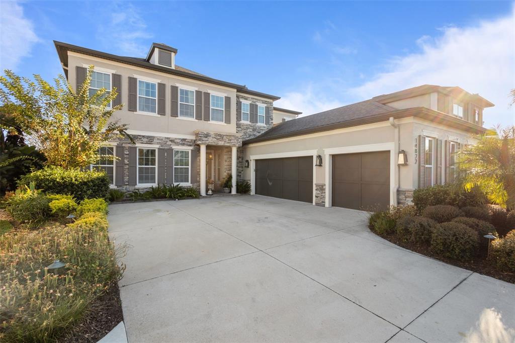 14822 Trails Edge Boulevard Odessa, FL 33556 - Photo 30 of 73 a front view of a house with a yard and garage