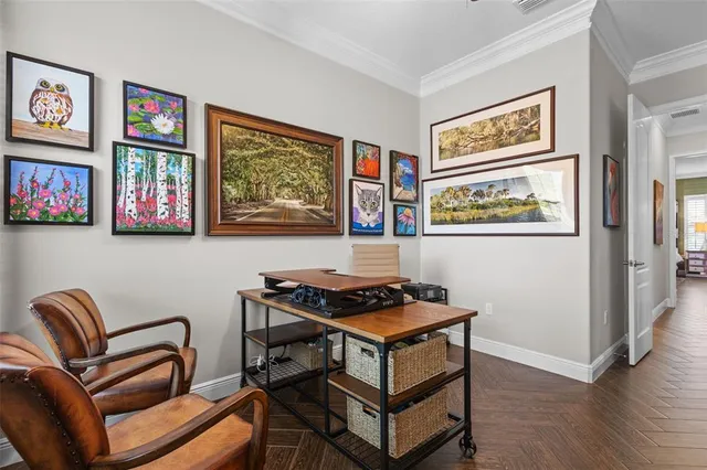 a bedroom with a bed and painting on the wall