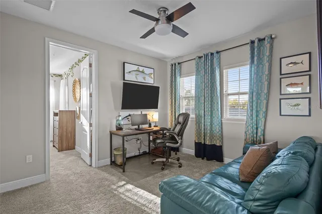 a front view of a house with a yard and potted plants